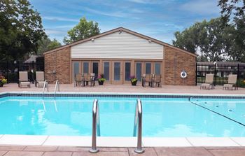 a brick building with a pool in front of it at Forest Glen, Midland, Michigan